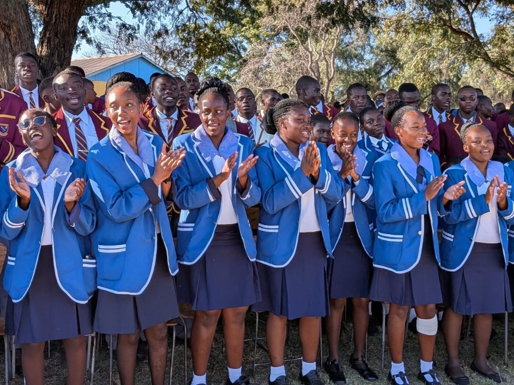 Usher choir students singing and clapping together